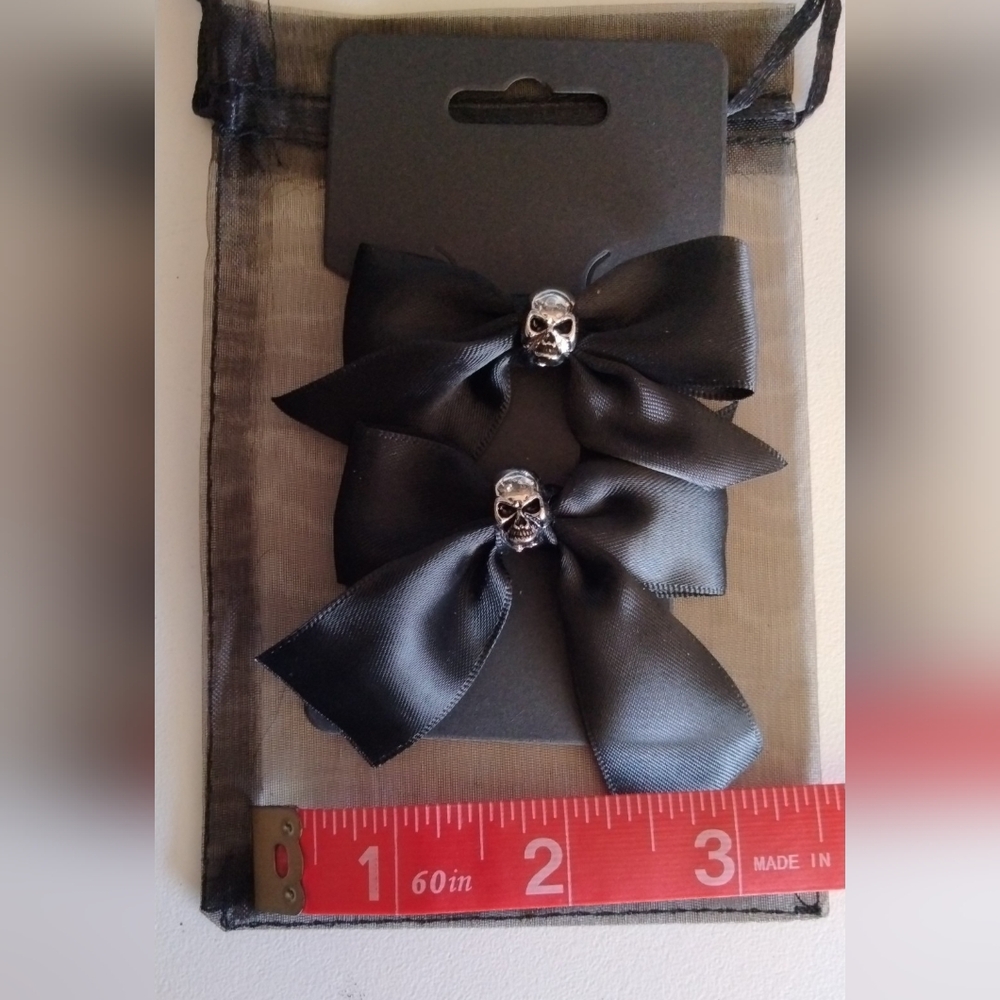 A Pair Of Elegant Black Skull Bow Hair Clips.